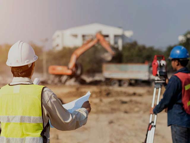 men surveying doing construction project management services
